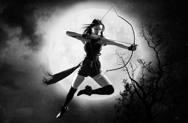 Bow and arrow in front of the moon