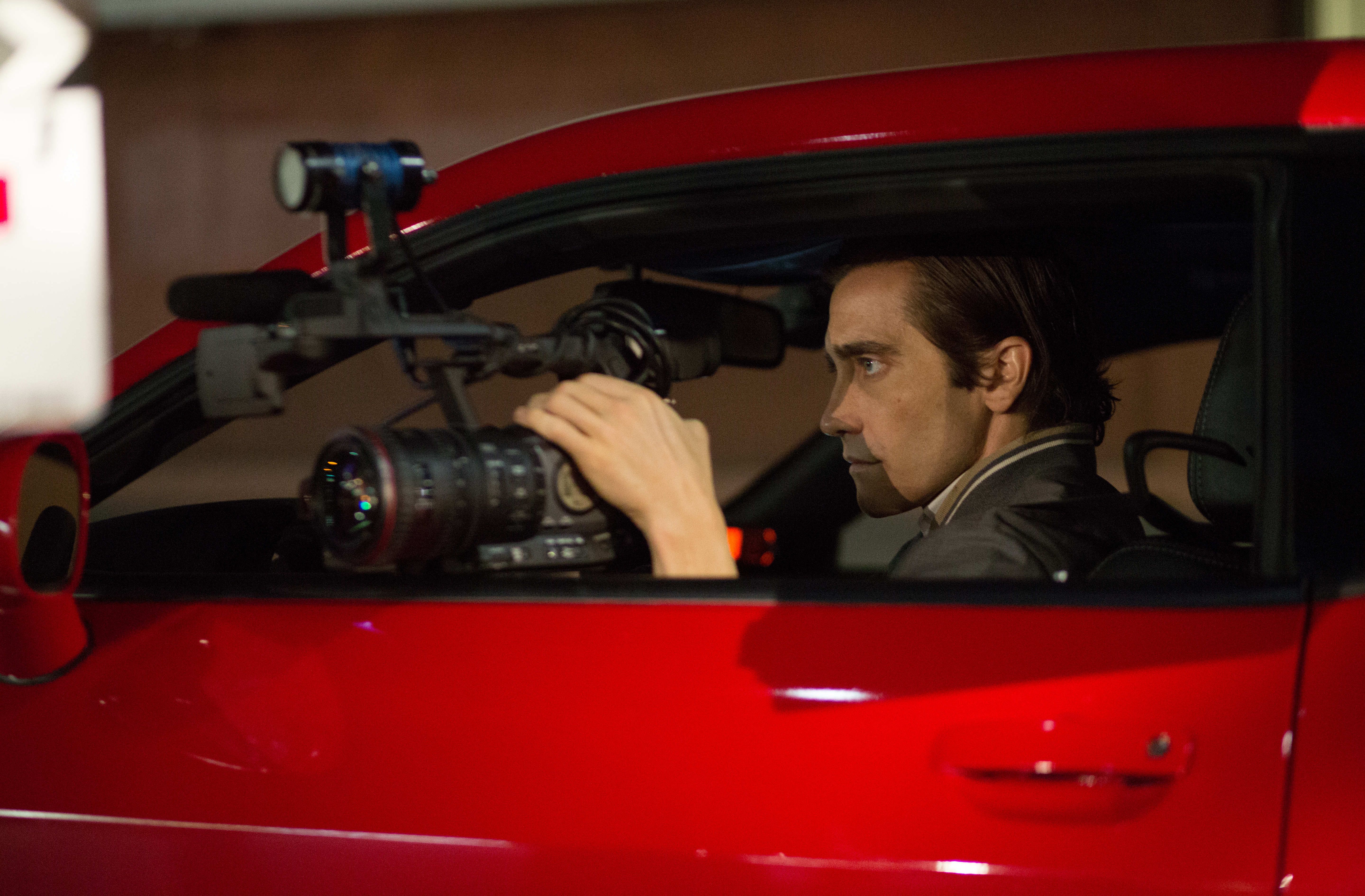 Jake Gyllenhaal filming from his red Challenger SRT8 392 in 