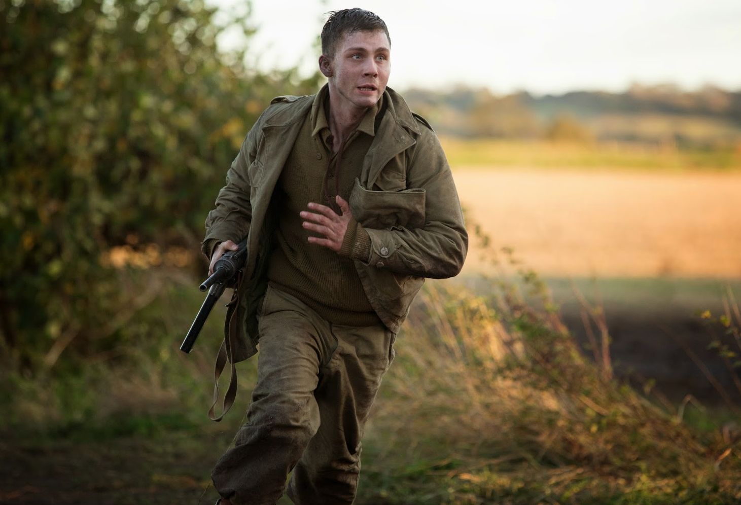 Logan Lerman running around as Norman Ellison in Fury