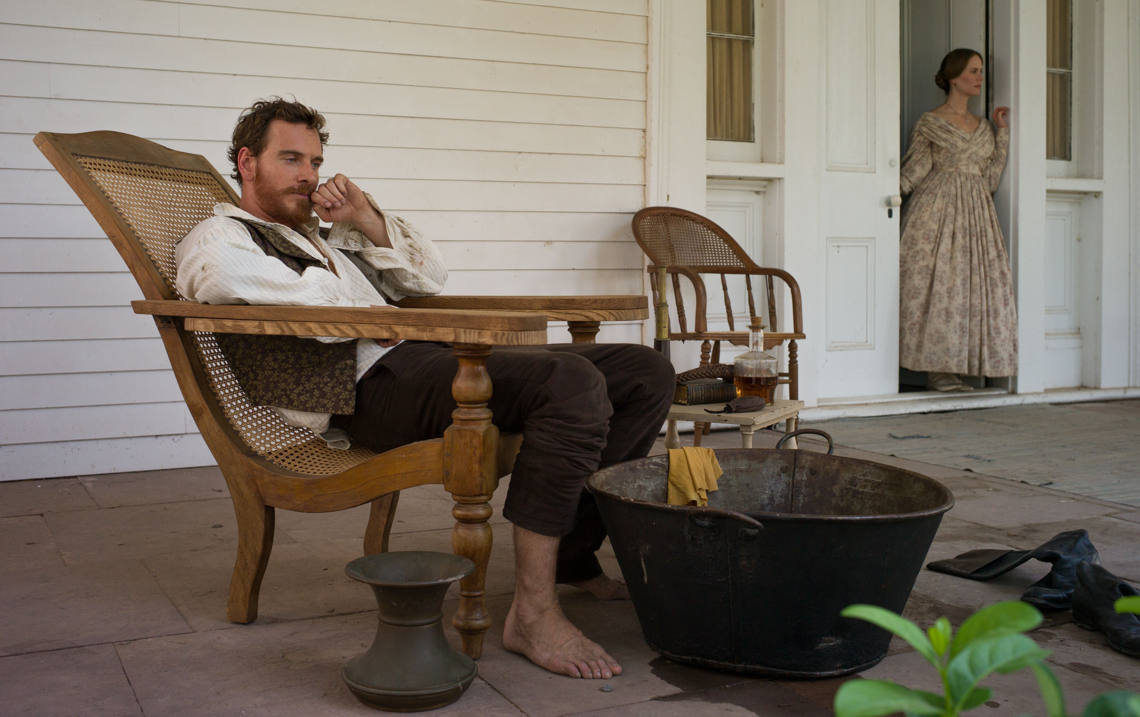 Michael Fassbender as Edwin Epps looking over his slaves fro
