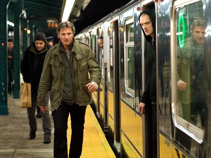Liam Neeson paces the platform
